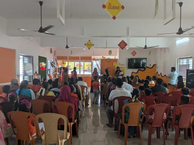 Parents at an orientation session in the centre's hall